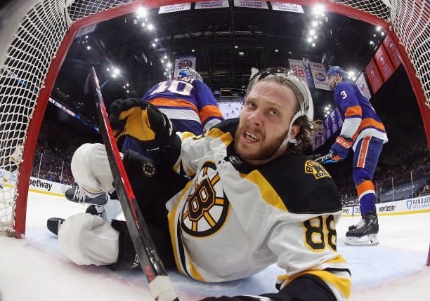 David Pastrnak of the Boston Bruins is knocked into the net during the second period against the New York Islanders in Game Four of the Second Round...