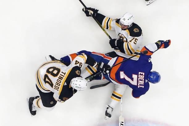 Connor Clifton of the Boston Bruins battles with Jordan Eberle of the New York Islanders during the first period in Game Four of the Second Round of...