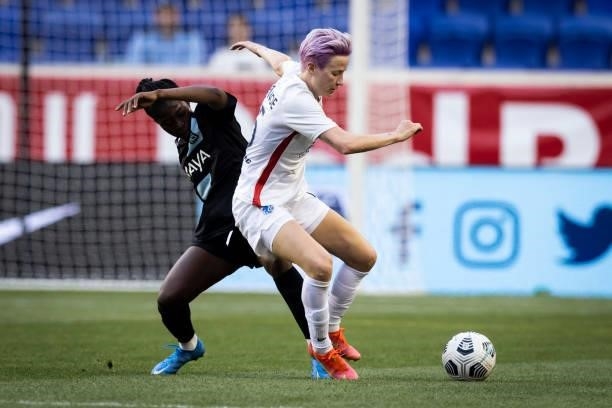 Megan Rapinoe of OL Reign battles for control of the ball against Mandy Freeman of NJ//NY Gotham FC during the first half of the game at Red Bull...