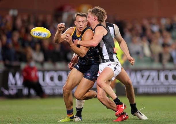 Tom Doedee of the Crows handballs during the round 12 AFL match between the Adelaide Crows and the Collingwood Magpies at Adelaide Oval on June 05,...