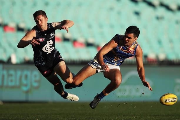 Marc Murphy of the Blues is bumped by Tom Cole of the Eagles of the Eagles during the round 12 AFL match between the Carlton Blues and the West Coast...