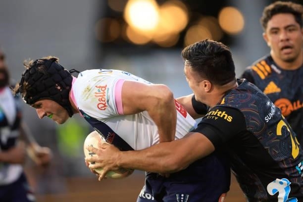 Michael Icely of the Rebels is tackled by Chase Tiatia of the Chiefs during the round four Super Rugby Trans-Tasman match between the Chiefs and the...