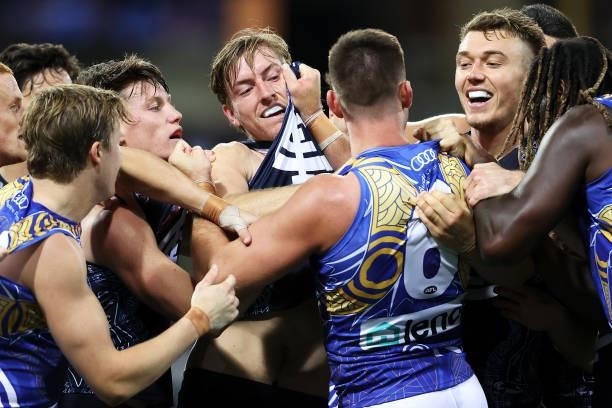 Elliot Yeo of the Eagles scuffles with Sam Walsh, Will Setterfield and Patrick Cripps of the Blues during the round 12 AFL match between the Carlton...