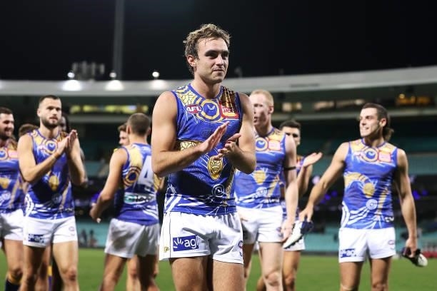 Luke Edwards of the Eagles leads his team off as they celebrate victory during the round 12 AFL match between the Carlton Blues and the West Coast...