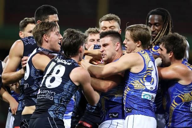 Jackson Nelson of the Eagles intervenes as Elliot Yeo of the Eagles scuffles with Sam Walsh and Will Setterfield of the Blues during the round 12 AFL...