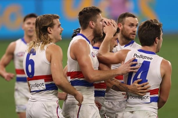 Team mates get around Tom Liberatore of the Bulldogs after kicking a goal during the round 12 AFL match between the Fremantle Dockers and the Western...