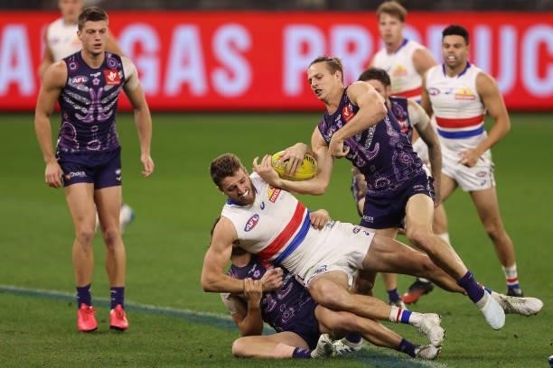 Marcus Bontempelli of the Bulldogs gets tackled by James Aish and Nat Fyfe of the Dockers during the round 12 AFL match between the Fremantle Dockers...