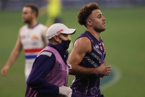 Griffin Logue of the Dockers comes from field after a hard clash with Aaron Naughton of the Bulldogs during the round 12 AFL match between the...