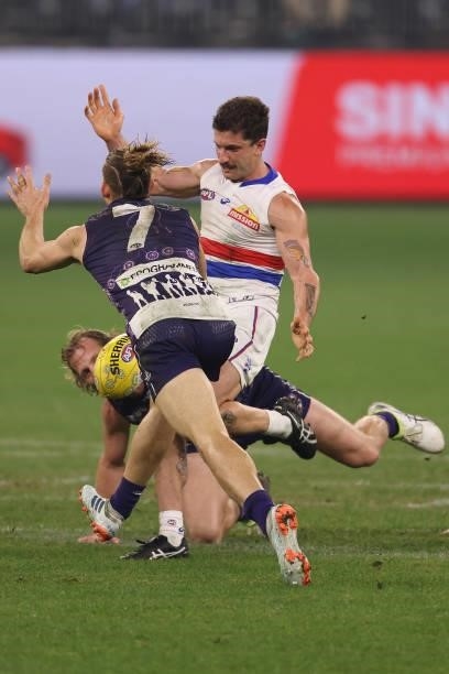 Nat Fyfe of the Dockers looks to smother the kick of Tom Liberatore of the Bulldogs during the round 12 AFL match between the Fremantle Dockers and...