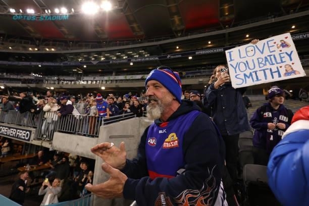 Bulldogs fans celebrate winning the round 12 AFL match between the Fremantle Dockers and the Western Bulldogs at Optus Stadium on June 06, 2021 in...
