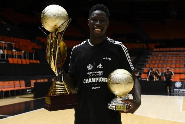 Eli John Ndiaye, #4 of U18 Real Madrid, poses with both Trphies after the Adidas Next Generation Tournament Championship Game between U18 Real Madrid...