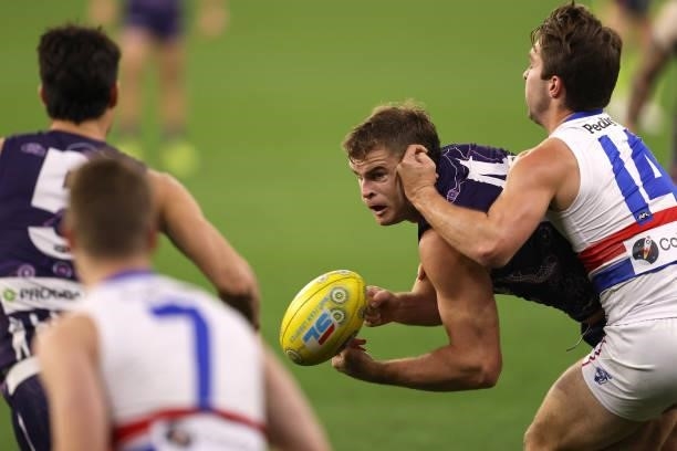 Sean Darcy of the Dockers handballs under pressure from Rhylee West of the Bulldogs during the round 12 AFL match between the Fremantle Dockers and...