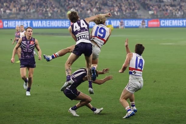Taylin Duman of the Dockers attempts to spoil the mark for Cody Weightman of the Bulldogs during the round 12 AFL match between the Fremantle Dockers...