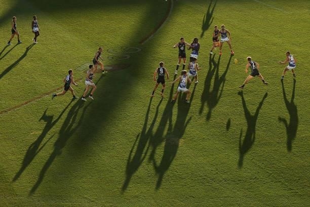 Players chase the down the ball during the round 12 AFL match between the Carlton Blues and the West Coast Eagles at Sydney Cricket Ground on June...