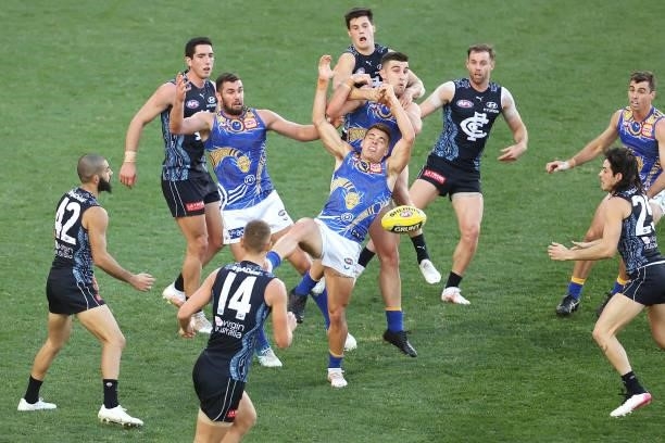 Players contest the ball during the round 12 AFL match between the Carlton Blues and the West Coast Eagles at Sydney Cricket Ground on June 06, 2021...