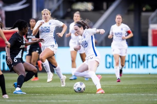 Rose Lavelle of OL Reign pushes forward during the first half of the match against NJ/NY Gotham FC at Red Bull Arena on June 5, 2021 in Harrison, New...