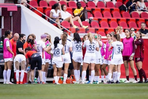 Members of the OL Reign team huddle during a mandatory water break during the first half of the match against NJ/NY Gotham FC at Red Bull Arena on...