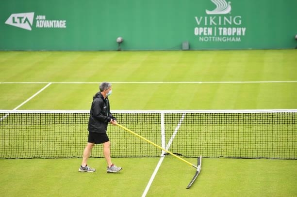 Member of staff prepares the court after rain stops play during day 2 of the Viking Open at Nottingham Tennis Centre on June 06, 2021 in Nottingham,...