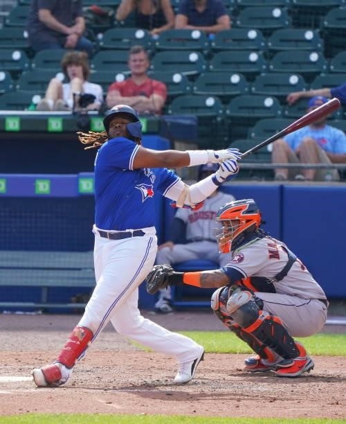 Vladimir Guerrero Jr. #27 of the Toronto Blue Jays and Martin Maldonado of the Houston Astros during the game at Sahlen Field on June 5, 2021 in...