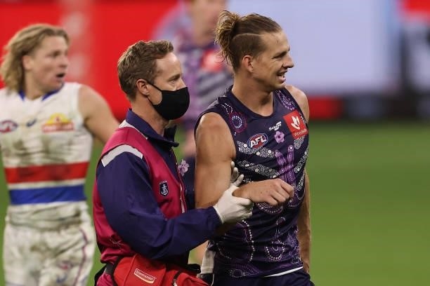 Nat Fyfe of the Dockers is assisted from the field with a shoulder injury during the round 12 AFL match between the Fremantle Dockers and the Western...