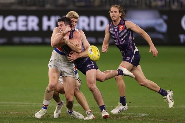 Andrew Brayshaw of the Dockers handballs against Rhylee West of the Bulldogs during the round 12 AFL match between the Fremantle Dockers and the...