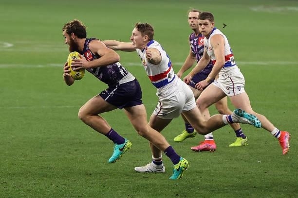 Connor Blakely of the Dockers looks to break clear of Bailey Dale of the Bulldogs during the round 12 AFL match between the Fremantle Dockers and the...