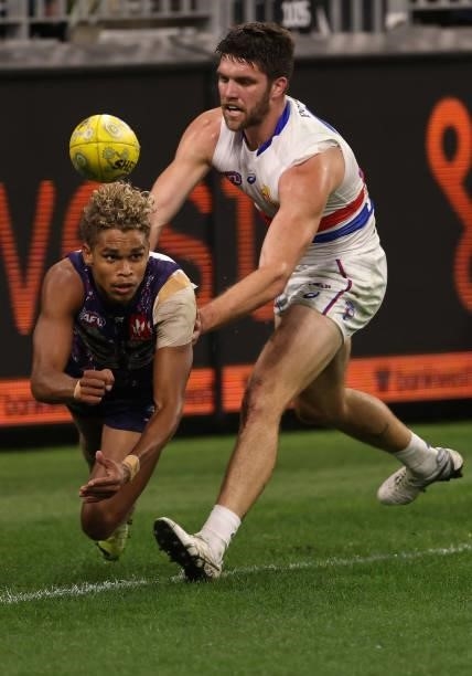 Liam Henry of the Dockers handballs during the round 12 AFL match between the Fremantle Dockers and the Western Bulldogs at Optus Stadium on June 06,...