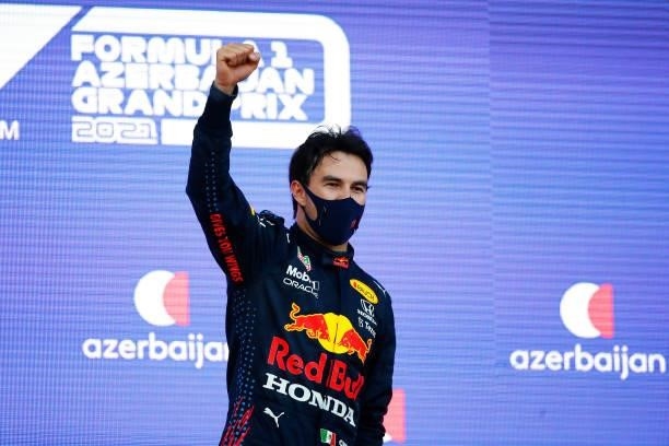 Race winner Sergio Perez of Mexico and Red Bull Racing celebrates on the podium during the F1 Grand Prix of Azerbaijan at Baku City Circuit on June...