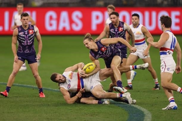 Nat Fyfe of the Dockers looks to win possession of the ball from Marcus Bontempelli of the Bulldogs during the round 12 AFL match between the...