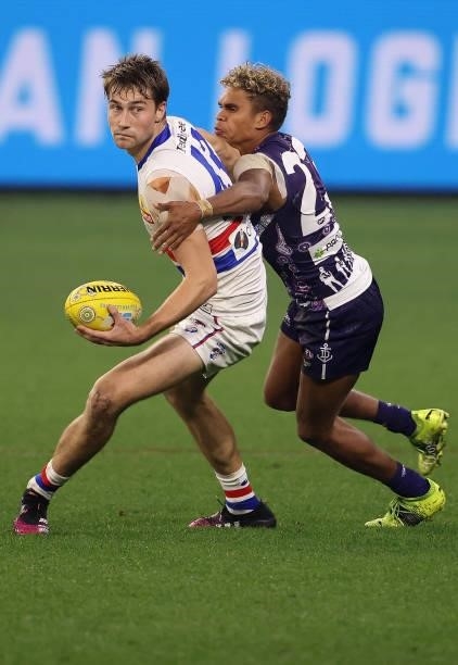 Liam Henry of the Dockers tackles Ryan Gardner of the Bulldogs during the round 12 AFL match between the Fremantle Dockers and the Western Bulldogs...