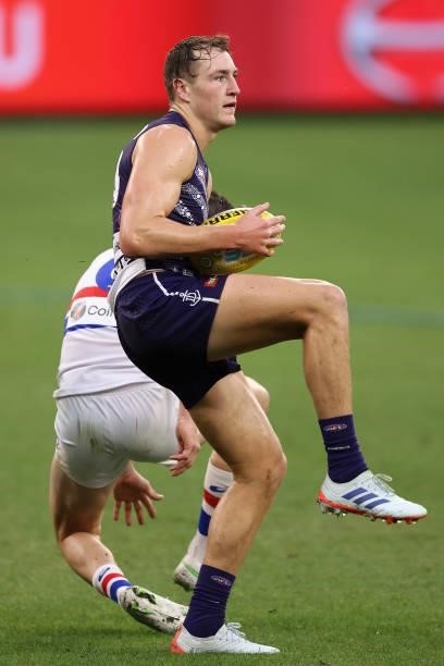 Brennan Cox of the Dockers marks the ball during the round 12 AFL match between the Fremantle Dockers and the Western Bulldogs at Optus Stadium on...