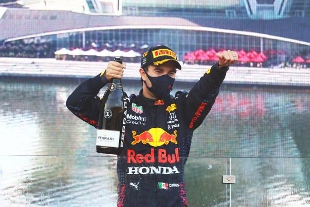 Race winner Sergio Perez of Mexico and Red Bull Racing celebrates with sparkling wine on the podium during the F1 Grand Prix of Azerbaijan at Baku...