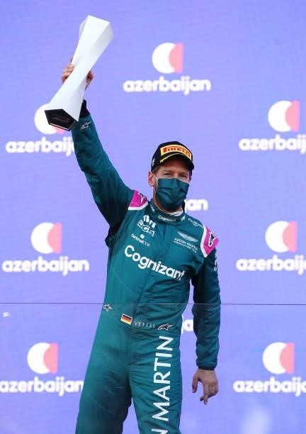 Second placed Sebastian Vettel of Germany and Aston Martin F1 Team celebrates on the podium during the F1 Grand Prix of Azerbaijan at Baku City...