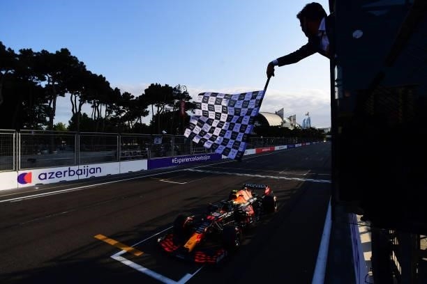 Race winner Sergio Perez of Mexico driving the Red Bull Racing RB16B Honda takes the chequered flag during the F1 Grand Prix of Azerbaijan at Baku...