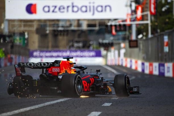 The rear left tyre of Max Verstappen of the Netherlands driving the Red Bull Racing RB16B Honda fails leading to a crash and his retirement during...