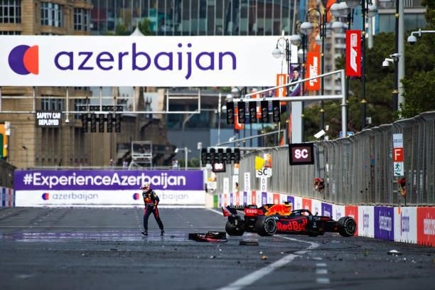 Max Verstappen of Netherlands and Red Bull Racing reacts as he walks back to the paddock after crashing during the F1 Grand Prix of Azerbaijan at...