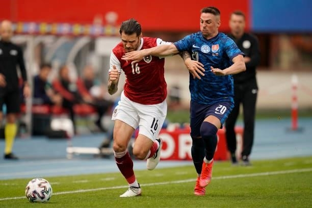 Christopher Trimmel of Austria battles for possession with Robert Mak of Slovakia during the international friendly match between Austria and...