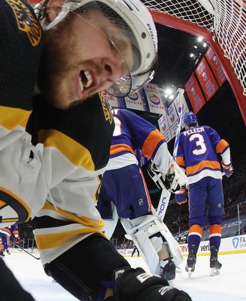 David Pastrnak of the Boston Bruins is knocked into the net during the second period against the New York Islanders in Game Four of the Second Round...