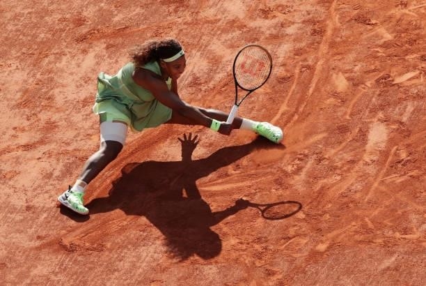 Serena Williams of USA stretches to play a forehand and slips over during her Women's Singles fourth round match against Elena Rybakina of Kazakhstan...