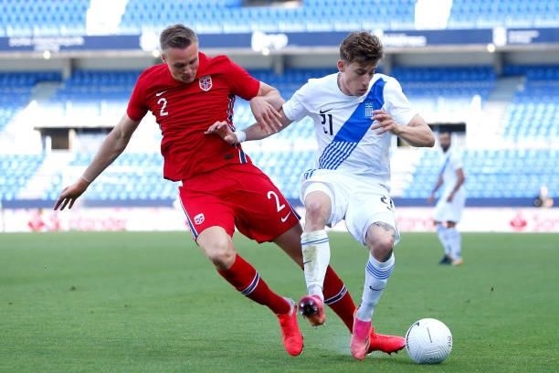 Kostas Tsimikas of Greece is challenged by Stian Gregersen of Norway during the International Friendly match between Norway and Greece at Estadio La...