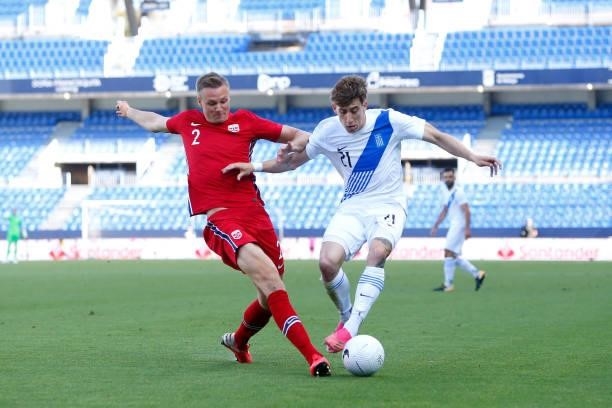 Kostas Tsimikas of Greece is challenged by Stian Gregersen of Norway during the International Friendly match between Norway and Greece at Estadio La...