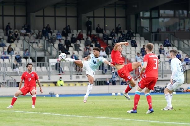 Che Adams of Scotland wins a header whilst under pressure from Dirk Carlson of Luxembourg during the international friendly match between Luxembourg...