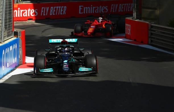 Lewis Hamilton of Great Britain driving the Mercedes AMG Petronas F1 Team Mercedes W12 leads Charles Leclerc of Monaco driving the Scuderia Ferrari...