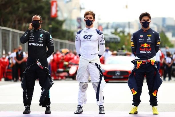Lewis Hamilton of Great Britain and Mercedes GP, Pierre Gasly of France and Scuderia AlphaTauri and Sergio Perez of Mexico and Red Bull Racing stand...