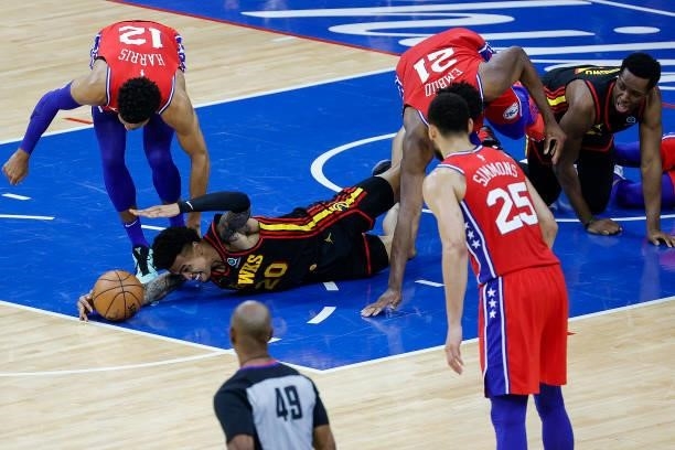 John Collins of the Atlanta Hawks reaches for a loose ball during the second quarter against the Philadelphia 76ers during Game One of the Eastern...