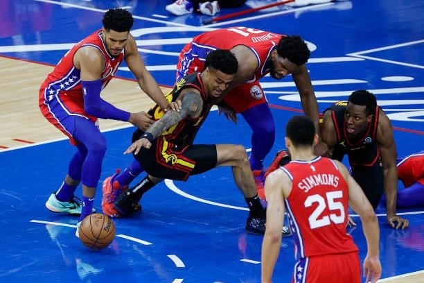 Tobias Harris of the Philadelphia 76ers and John Collins of the Atlanta Hawks reach for the ball during the second quarter during Game One of the...