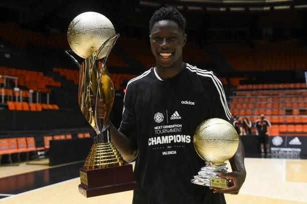Eli John Ndiaye, #4 of U18 Real Madrid poses with both trphies after the Adidas Next Generation Tournament Championship Game between U18 Real Madrid...