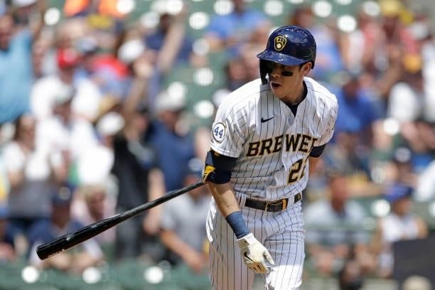Christian Yelich of the Milwaukee Brewers flips the bat behind his back while flying out to the wall in the first inning against the Arizona...