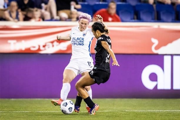 Megan Rapinoe of OL Reign battles with Nahomi Kawasumi of NJ/NY Gotham FC during the second half of the match against at Red Bull Arena on June 5,...