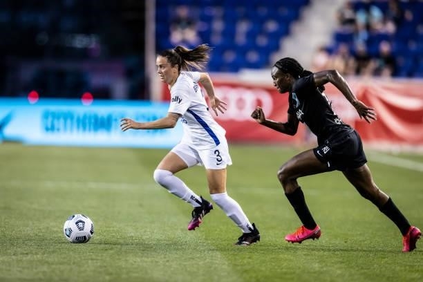 Lauren Barnes of OL Reign tries to outrun Ifeoma Onumonuduring of NJ/NY Gotham FC the second half of the match at Red Bull Arena on June 5, 2021 in...